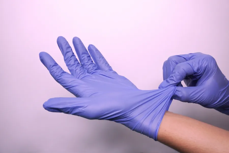 Nitrile medical gloves being worn for safety and hygiene purposes.